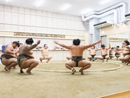 Sumo wrestlers practice and exercise in the ring