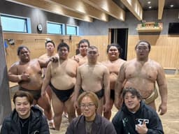 Sumo wrestlers pose for photo with guests